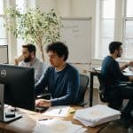 Employees discussing retention in corner office