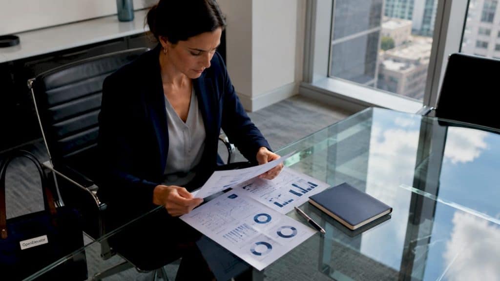 Leader analyzing team scan report at conference table