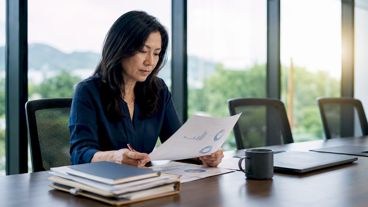 HR manager reviewing turnover cost reports
