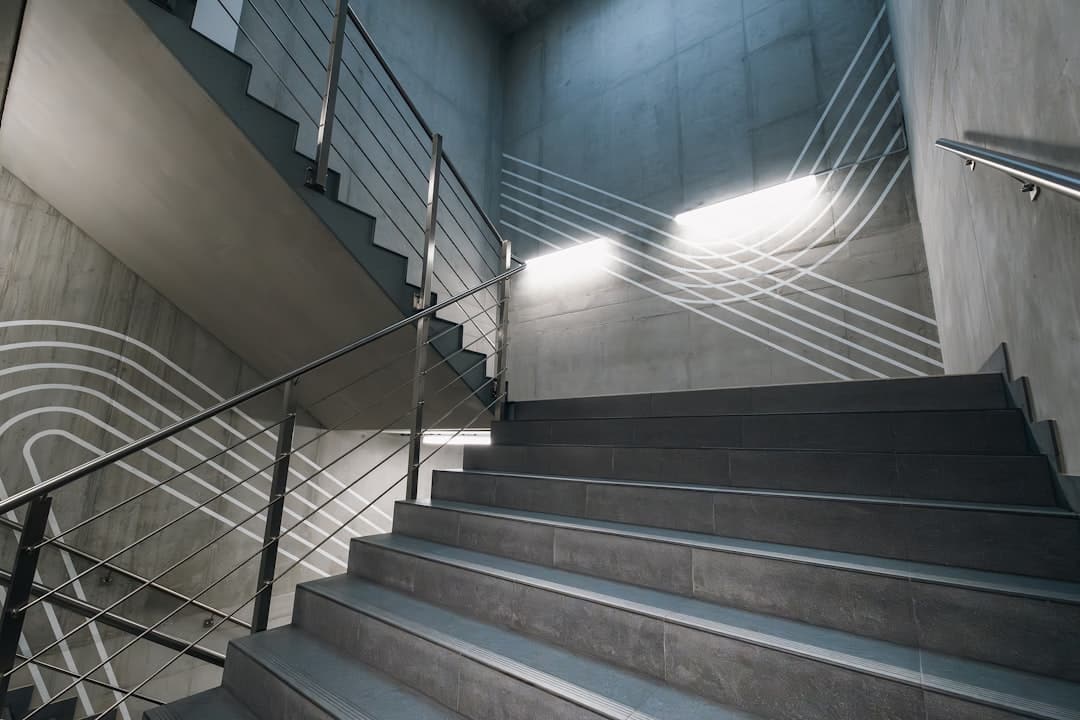 Modern corporate stairwell with glass and shadows