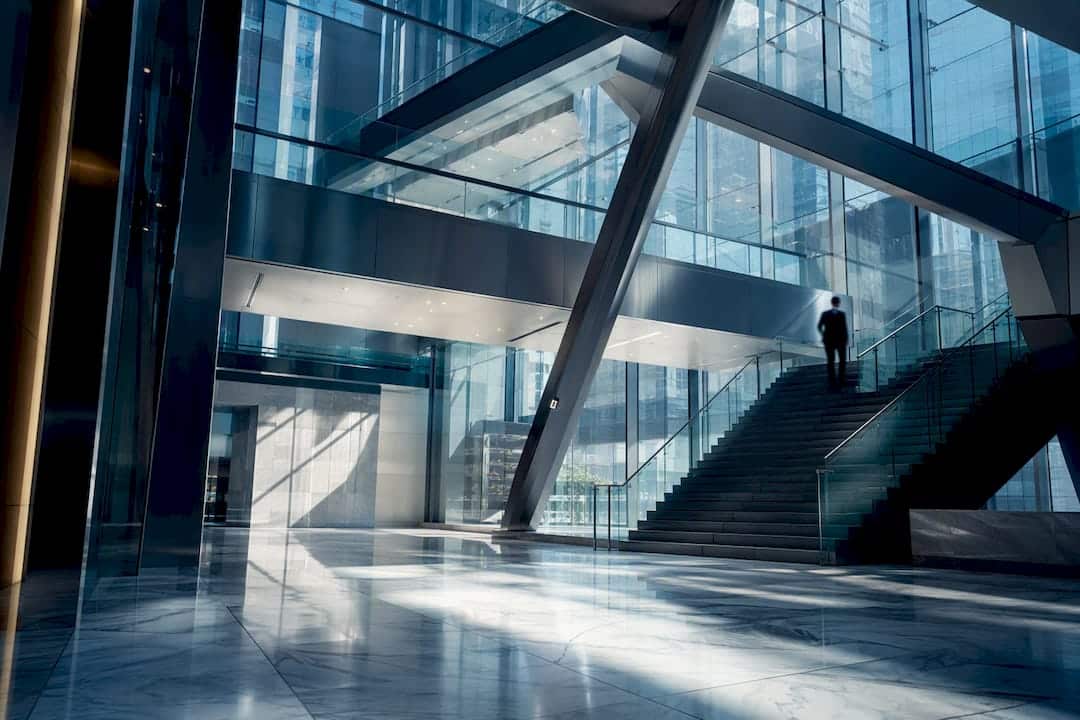 Modern atrium with glass staircases and shadows