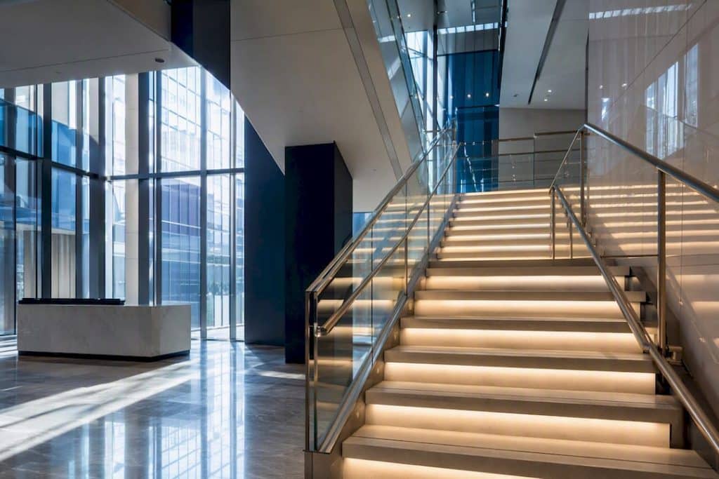 Modern office stairwell with lighting and glass