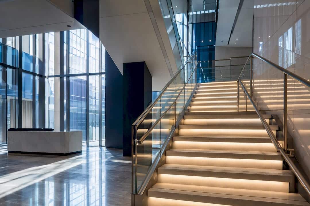 Modern office stairwell with lighting and glass